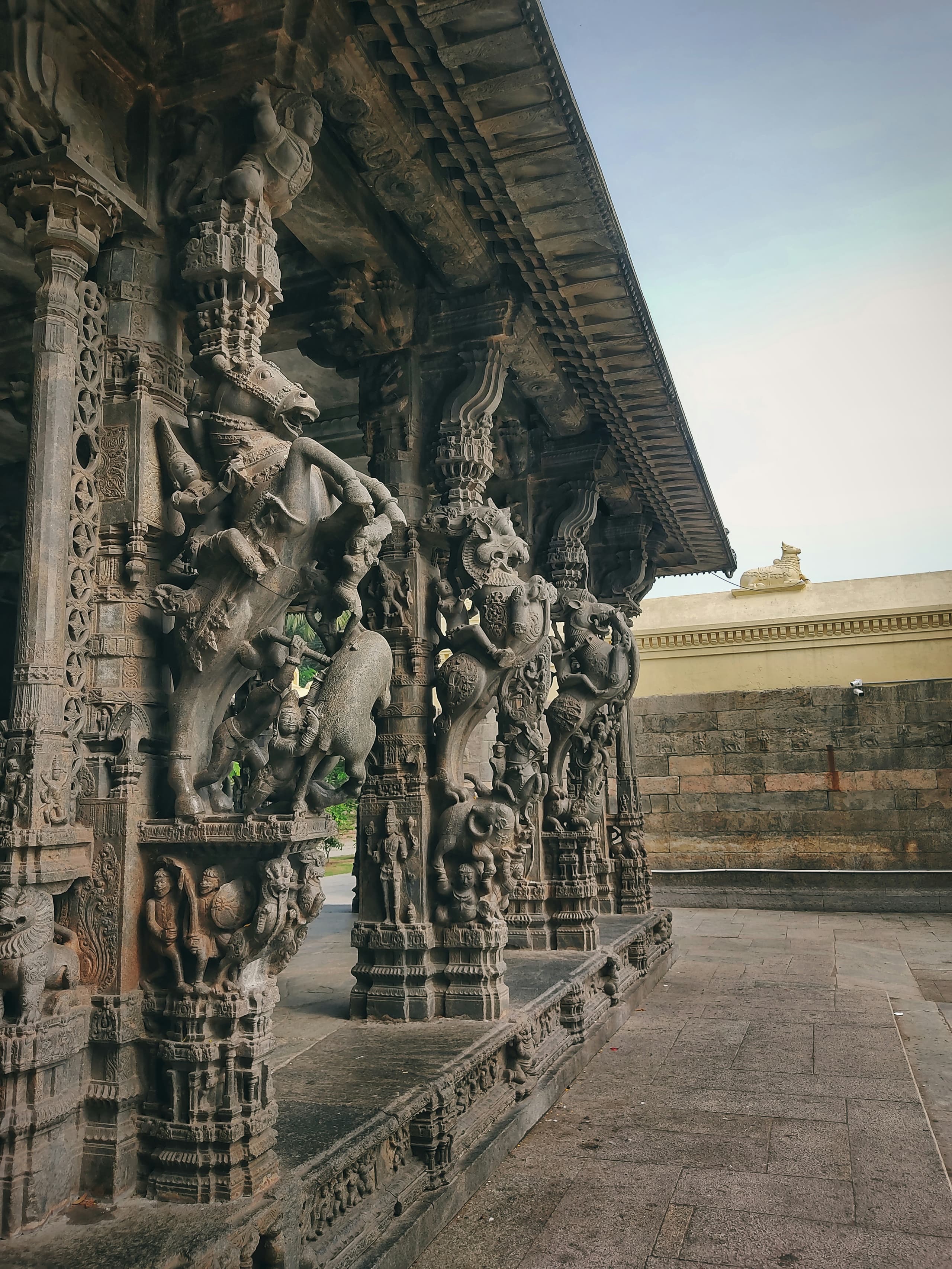 Intricately carved temple pillars with rearing horses and riders