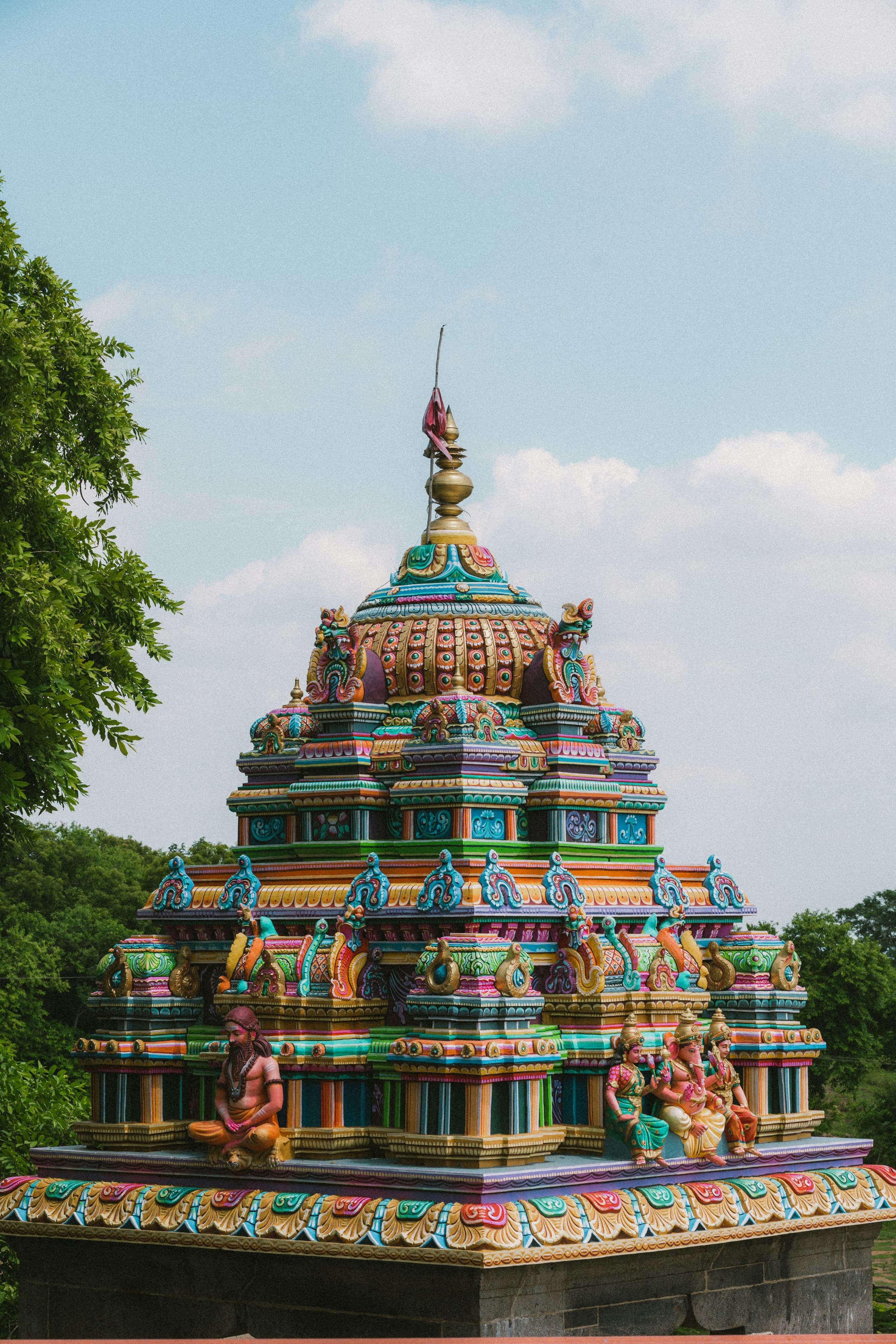 A small brightly painted shrine with a seated figure of Lord Hanuman on its plinth